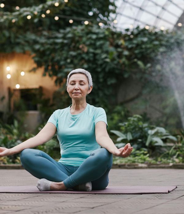 Woman in a serene yoga pose, embodying peace and balance.